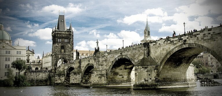 Historic stone bridge over river with people